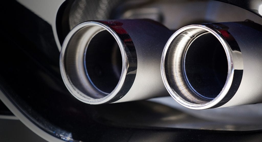 Closeup view of a high performance exhaust system, chrome with matte finish
